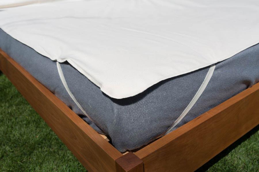Soaring Heart Organic Cotton Mattress Protector on a bed