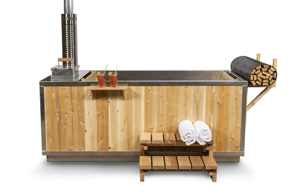 Canadian Timber Starlight Wood Burning Hot Tub on a white background, three-quarter view showing the cedar cabinet, stainless steel rim, external wood stove and chimney, drinks shelf and cedar entry steps