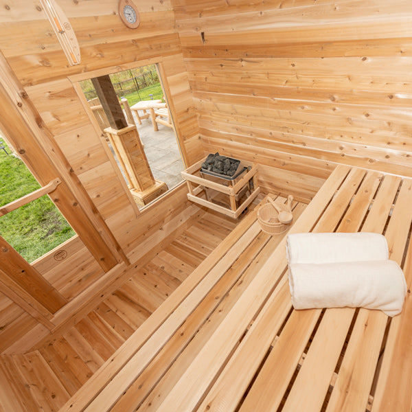 Luna Sauna interior with the electric heater, stones and safety railing