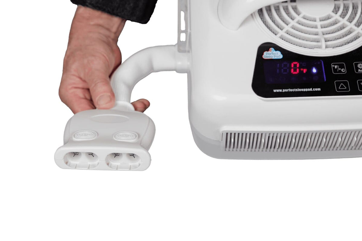 Close-up of the Perfect Sleep Pad control unit display and the quick-connect hose coupling