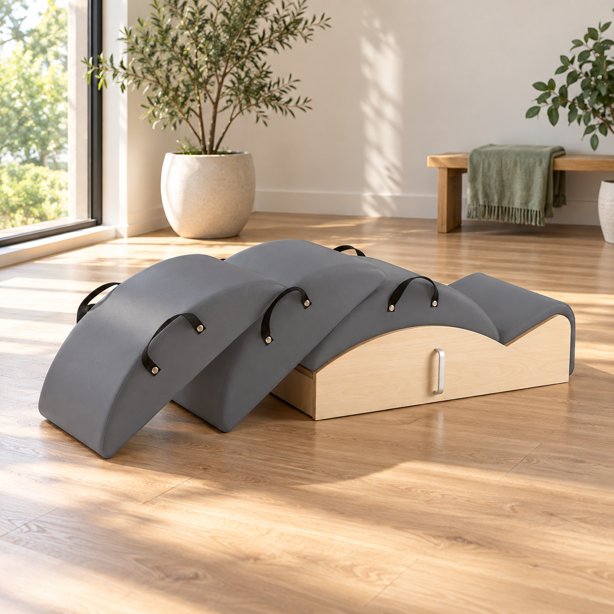 Elina Pilates Spine Corrector 3 in 1 set in grey on an oak floor in a bright Pilates studio