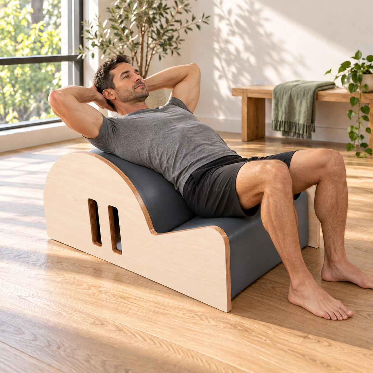 Man in a supported back extension over the Elina Pilates Spine Corrector Elite