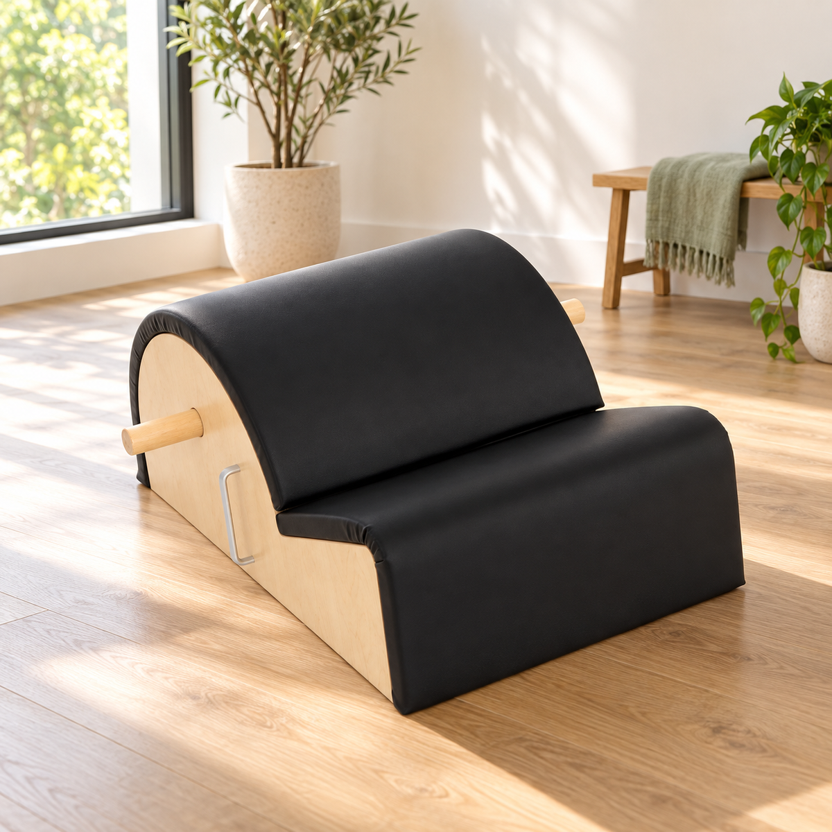 Elina Pilates Spine Corrector in black on an oak floor in a bright Pilates studio