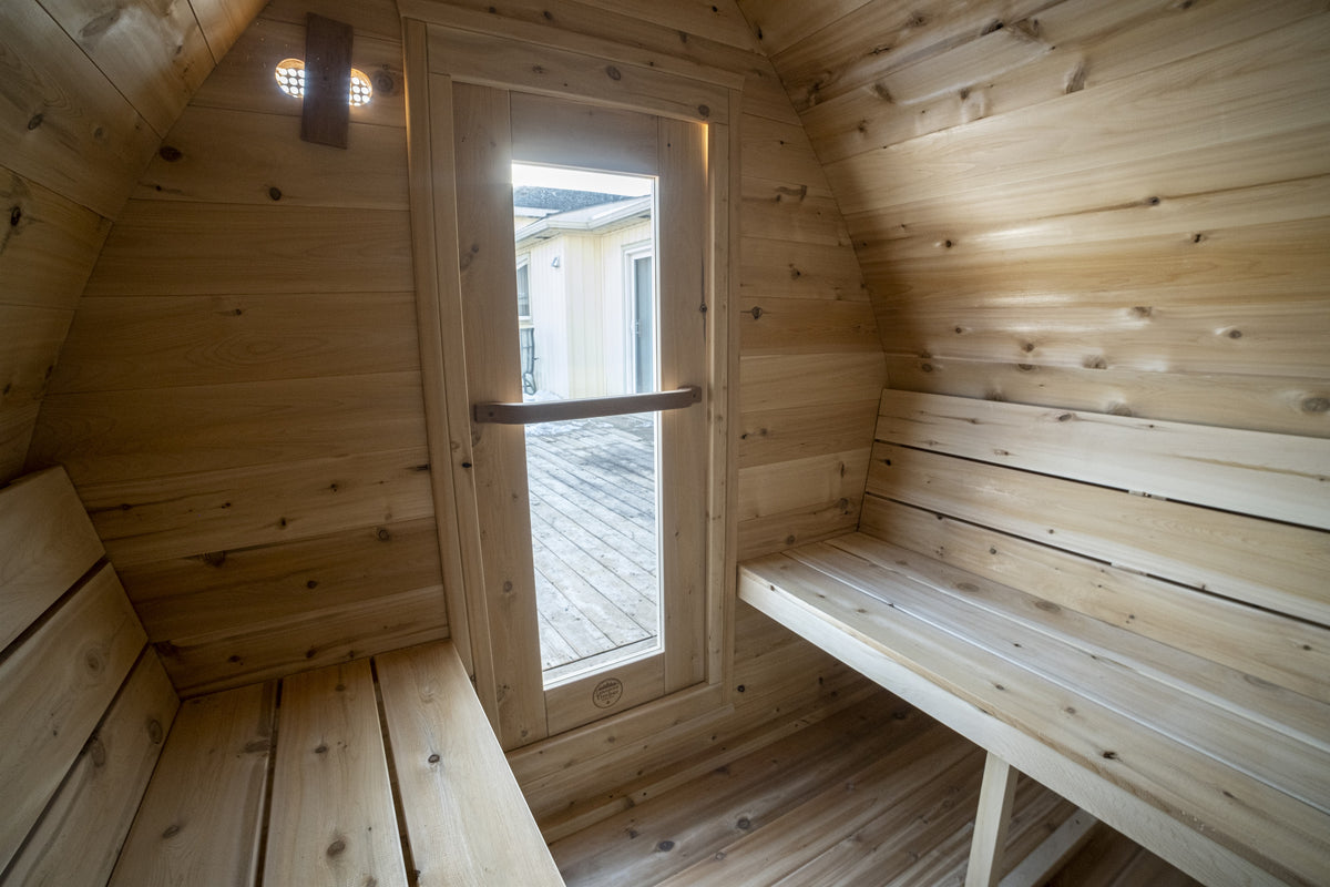 MiniPOD Sauna interior from the opposite corner, showing bench length and the cedar-lined arch ceiling