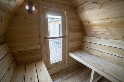 MiniPOD Sauna interior from the opposite corner, showing bench length and the cedar-lined arch ceiling