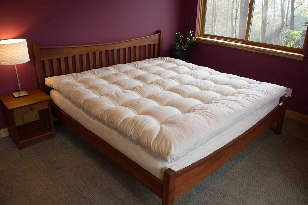 Holy Lamb Organics Certified Organic Quilted Topper on a bed